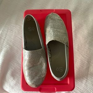 Silver sparkly shoes. Fit similar to Toms flats-not a lot of stretch.